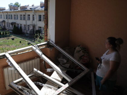 LVIV, UKRAINE - AUGUST 15: Woman stand near broken window after missile fragment hit an ap