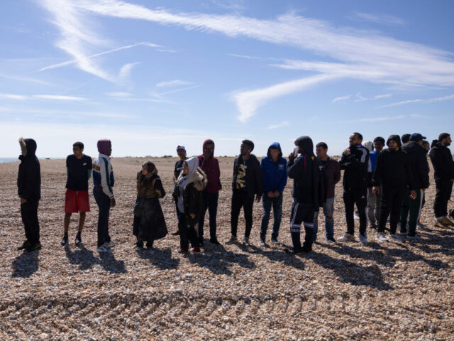 DUNGENESS, ENGLAND - AUGUST 16: Migrant families line up after being helped ashore on Dung
