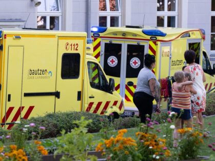 23 August 2023, Saxony, Bischofswerda: Ambulances stand in the schoolyard of an elementary