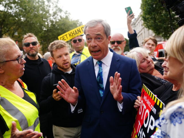 Nigel Farage speaks with protesters outside Downing Street in central London, on the first
