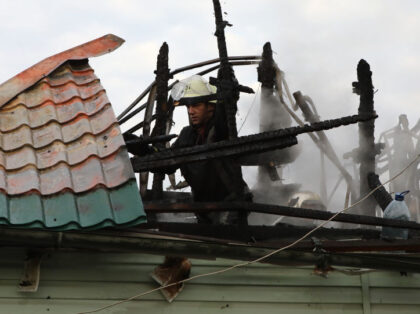 TARASIVKA, UKRAINE - AUGUST 30, 2023 - A State Emergency Service worker dismantles the roof of a fire-stricken house after Russian overnight aerial attacks, Tarasivka village, Kyiv Region, northern Ukraine. Ukrainian air defence forces destroyed all 28 Russian cruise missiles and 15 out of 16 combat drones last night. NO …