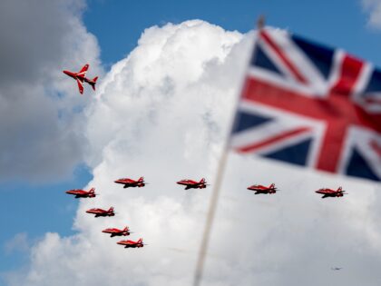 BIGGIN HILL, ENGLAND - AUGUST 19: The Royal Air Force Red Arrows fly past a Union Jack whilst departing for another air show at the Biggin Hill Festival of Flight on August 19, 2017 in Biggin Hill, England. The Biggin Hill Festival of Flight is an annual airshow event and …