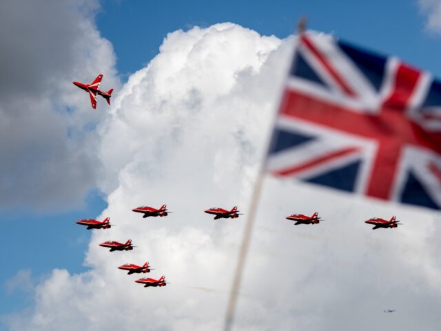 BIGGIN HILL, ENGLAND - AUGUST 19: The Royal Air Force Red Arrows fly past a Union Jack whi