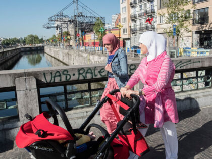 MOLENBEEK, BRUSSELS, BELGIUM - 2018/05/10: Two Muslim women walk across a bridge in Brussels. The bridge separates the Muslim district of Molenbeek from the rest of the city. Molenbeek is one of 19 districts that make up Brussels, the capital city of Belgium. In recent history Molenbeek has become infamous …