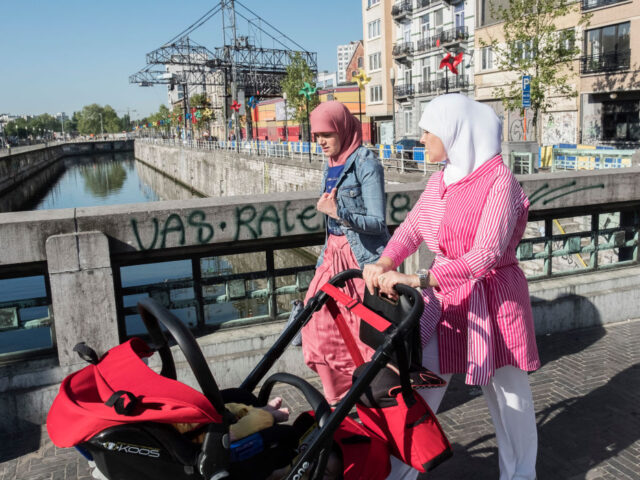 MOLENBEEK, BRUSSELS, BELGIUM - 2018/05/10: Two Muslim women walk across a bridge in Brusse