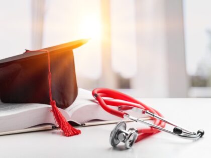 Stethoscope and graduate hat with book