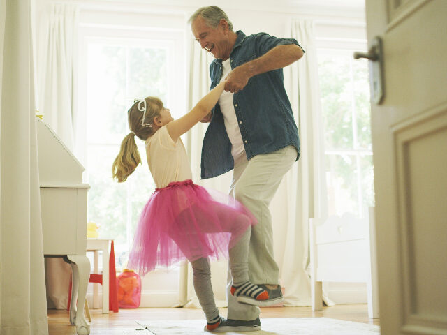 Shot of a senior man having fun with his granddaughter at home