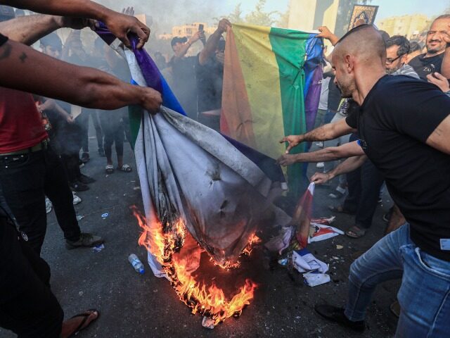 30 June 2023, Iraq, Baghdad: Protesters burn the LGBT (lesbian, gay, bisexual and transgen