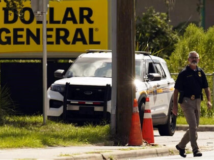 Law enforcement officials continue their investigation at a Dollar General Store that was