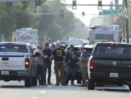 Law enforcement officials investigate the scene of a mass shooting at a Dollar General store, Saturday, Aug. 26, 2023, in Jacksonville, Fla. (John Raoux, File/AP)