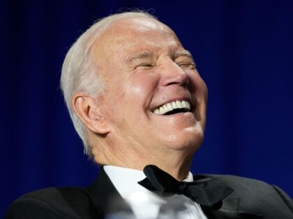 President Joe Biden laughs as comedian Roy Wood Jr., a correspondent for "The Daily S