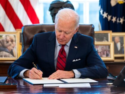 WASHINGTON, DC - JANUARY 28: U.S. President Joe Biden signs executive actions in the Oval