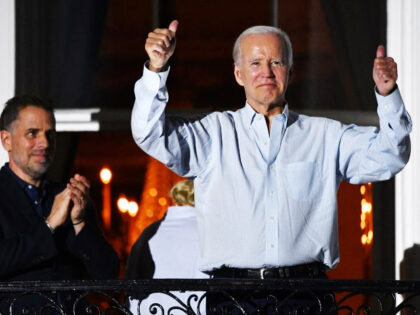 President Joe Biden gives two thumbs up from a balcony of the White House as his son Hunte