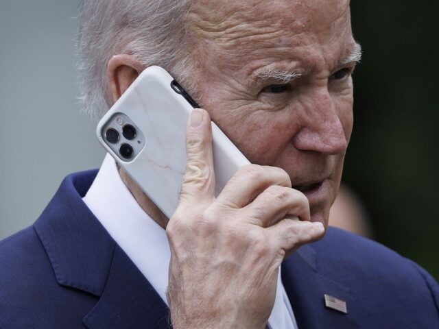 US President Joe Biden on a smartphone during a National Small Business Week event in the Rose Garden of the White House in Washington, DC, US, on Monday, May 1, 2023. The White House said Biden administration investments in America has led to 10.5 million applications to start small businesses …
