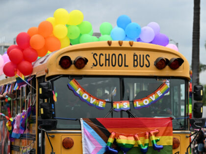 school bus adorned with rainbow colors is the YMCA entry to the 2023 LA Pride Parade on Ju