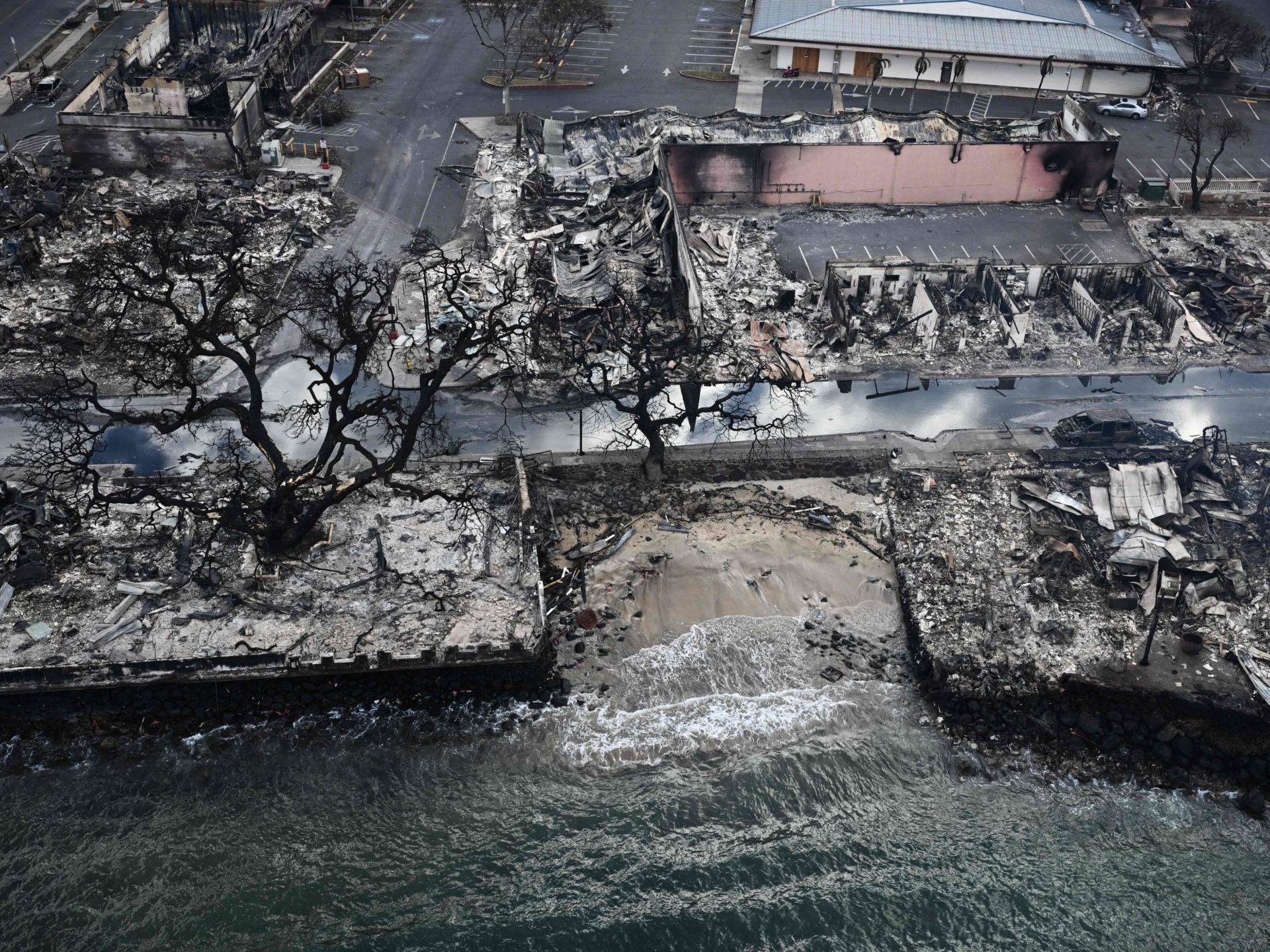 OPSHOT - An aerial image taken on August 10, 2023 shows destroyed homes and buildings on the waterfront burned to the ground in Lahaina in the aftermath of wildfires in western Maui, Hawaii. At least 36 people have died after a fast-moving wildfire turned Lahaina to ashes, officials said August 9, 2023 as visitors asked to leave the island of Maui found themselves stranded at the airport. The fires began burning early August 8, scorching thousands of acres and putting homes, businesses and 35,000 lives at risk on Maui, the Hawaii Emergency Management Agency said in a statement. (Photo by Patrick T. Fallon / AFP) (Photo by PATRICK T. FALLON/AFP via Getty Images)