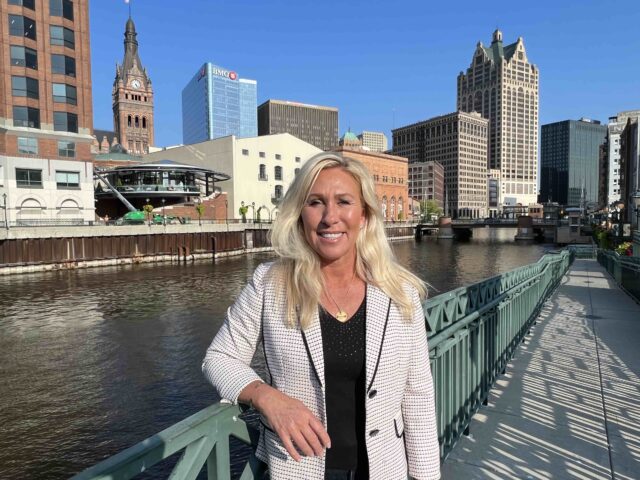 Marjorie Taylor Green stands on the River Walk next to the Milwaukee River in Milwaukee, Wisconsin, where the Republican Party will hold the first debate of the 2024 presidential primary. August 22, 2023 (Joel Pollak / Breitbart News)