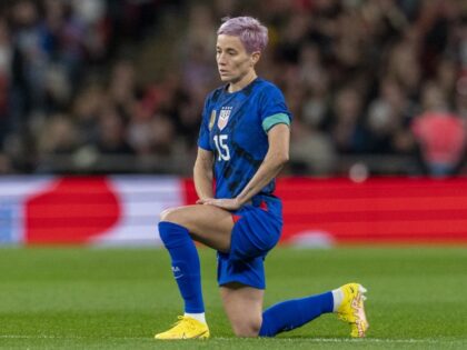 Megan Rapinoe #15 of the United States kneels during a game between England and USWNT at W