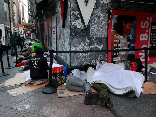 Hundreds of migrants are seen sleeping outside the Roosevelt Hotel in Midtown Manhattan ea
