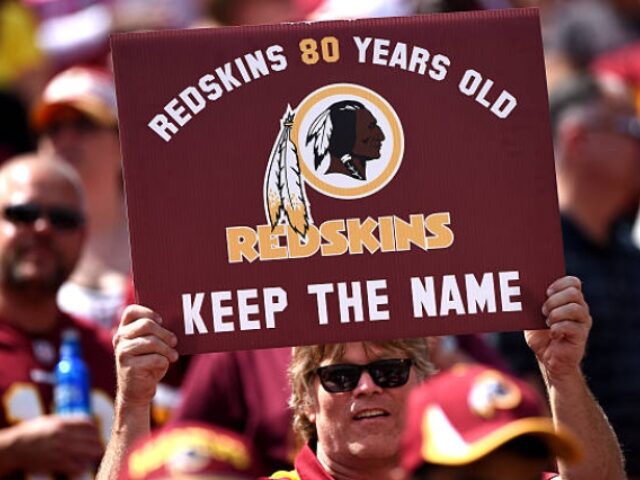 LANDOVER, MD - SEPTEMBER 14: A Washington Redskins fan holds up a sign to keep the Redskin