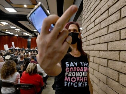 A gay and transgender students’ rights supporter gestures towards the camera during a Ch