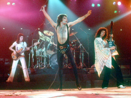 British rock band Queen perform in concert with Freddie Mercury wearing black leotard at t