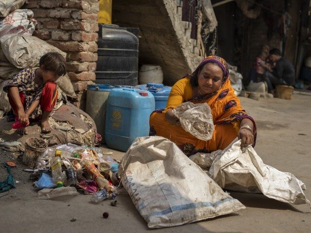 Sahra Bano sorts reusable items from the Bhalswa landfill on the outskirts of New Delhi, I