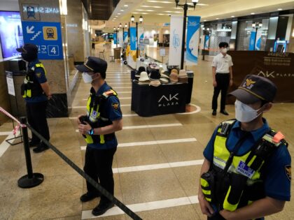 Police officers cordon off the scene near a subway station in Seongnam, South Korea, Thurs
