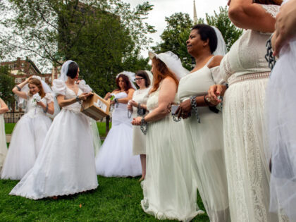 Advocates and child marriage survivors from the group "Unchained at Last" put on wedding gowns, veils, chains and tape over their mouths as they gather on Boston Common before marching to the State House to call for an end to child marriages in Boston, Massachusetts on September 22, 2021. - …