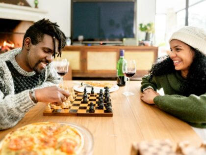 TV off couple playing chess