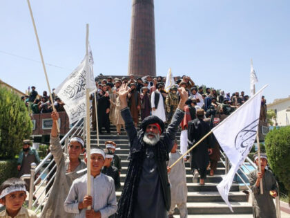 KABUL, AFGHANISTAN - AUGUST 15: Afghan people holding flags celebrate on the 2nd anniversary of Taliban takeover in Kabul, Afghanistan on August 15, 2023. (Bilal Guler/Anadolu Agency via Getty)