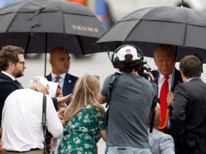ARLINGTON, VIRGINIA - AUGUST 03: Walt Nauta (L) looks on as former U.S. President Donald Trump (R) talks with members of the media on the tarmac at Reagan National Airport following an arraignment in a Washington, D.C. court on August 3, 2023 in Arlington, Virginia. Former U.S. President Donald Trump …