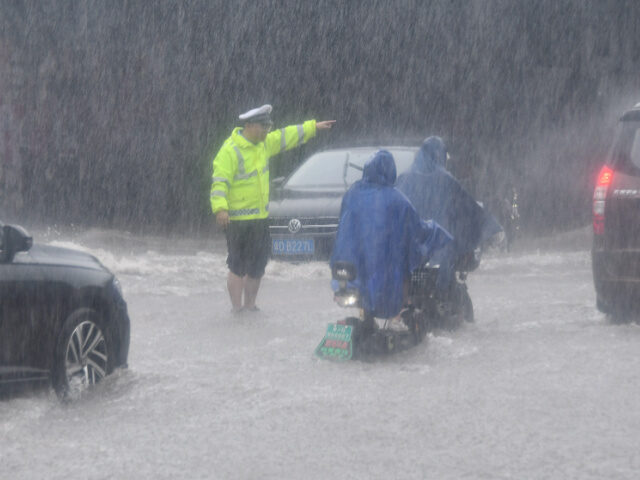 HANDAN, CHINA - JULY 30, 2023 - Traffic police guide vehicles through heavy rain in Handan