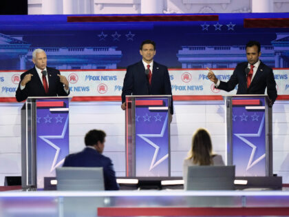 Former Vice President Mike Pence and businessman Vivek Ramaswamy talk as former New Jersey Gov. Chris Christie and Florida Gov. Ron DeSantis listen during a Republican presidential primary debate hosted by FOX News Channel Wednesday, Aug. 23, 2023, in Milwaukee. (AP Photo/Morry Gash)