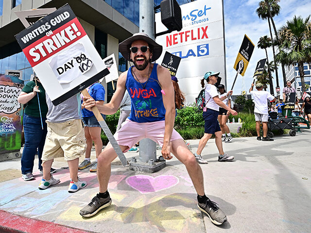 Writer and WGA member Alberto Roldan dances to electronic dance music as members of the Writers Guild of America (WGA) and the Screen Actors Guild walk the picket line outside of Netflix in Hollywood, California, on August 9, 2023. Film and TV production ground to a halt 100 days ago …