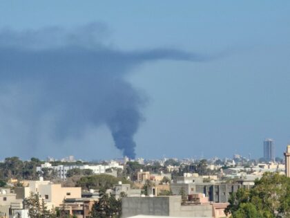 Smoke billows amid clashes between armed groups affiliated with Libya's Tripoli-based