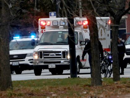 An ambulance believed to be carrying an injured Chicago police officer departs Mercy Hospi