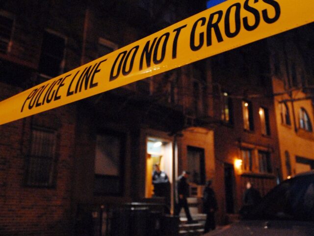 NEW YORK - FEBRUARY 22: Police tape hangs outside the apartment building at 31 Downing Str