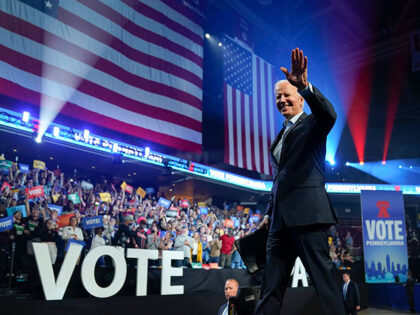 President Joe Biden waves as he walks off stage after speaking at a campaign rally for Pen