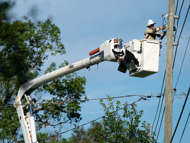 PERRY, FLORIDA - AUGUST 31: A lineman works to restore service in the aftermath of Hurrica