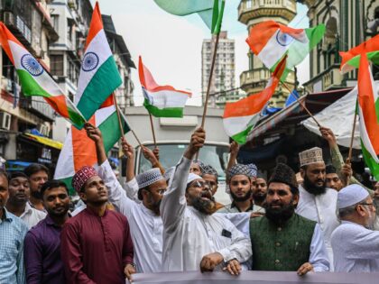Muslims wave national flags as they celebrate the successful lunar landing of Chandrayaan-