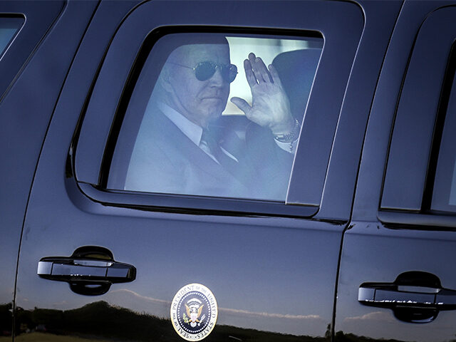 President Joe Biden waves from his motorcade in Washington, DC, on May 18, 2021. (Oliver C
