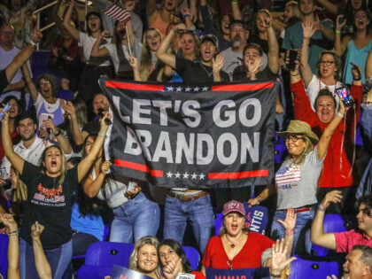 Attendees wave "Let's go Brandon" banners as they attend a "Don't