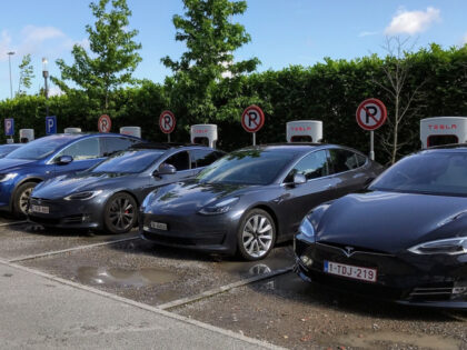 Electric cars are charging at a Tesla charging station.