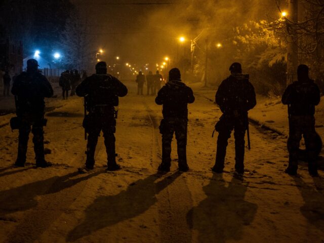Police officers guard a Diarco supermarket after an attempted looting, in Bariloche, Rio N