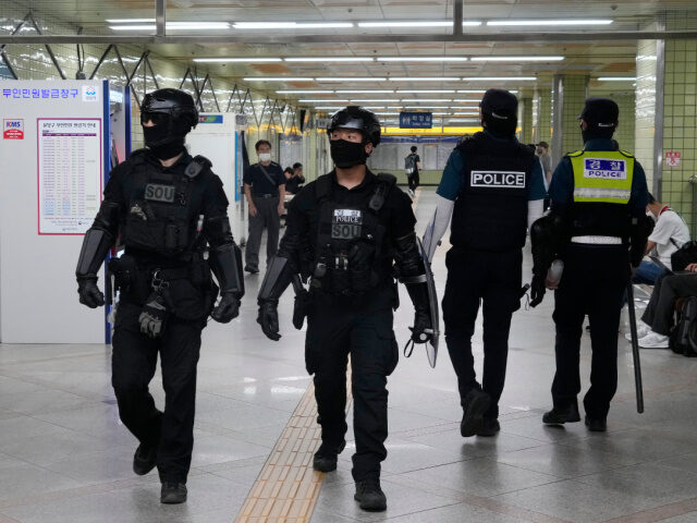 Police officers patrol at Ori subway station following Thursday's attack in Seongnam, Sout
