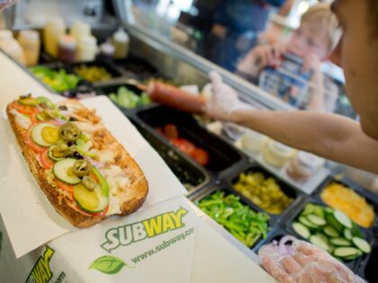 A worker makes a sandwich inside the fast food chain Subway in Hannover, Germany, 21 August 2015. The sandwich fast food chain will celebrate its 50th birthday on 28 August 2015. Photo: Julian Stratenschulte/dpa | usage worldwide (Photo by Julian Stratenschulte/picture alliance via Getty Images)