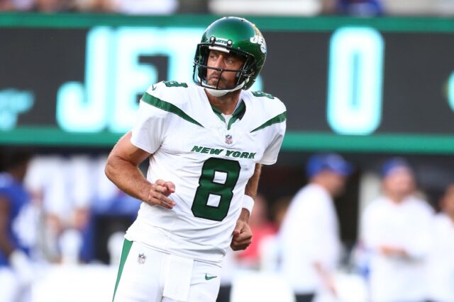 Aaron Rodgers of the New York Jets reacts after throwing a first quarter touchdown pass to