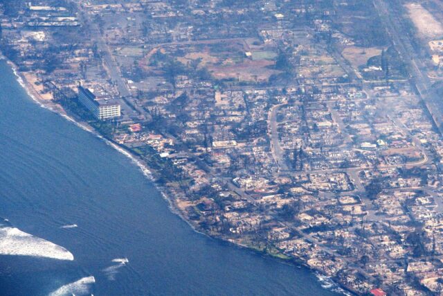 An aerial view of damaged buildings as a wildfire burns in Maui, Hawaii, on August 9, 2023