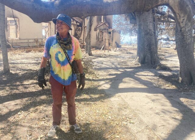 Anthony Garcia stands under a charred banyan tree -- the spiritual center of Lahaina -- i